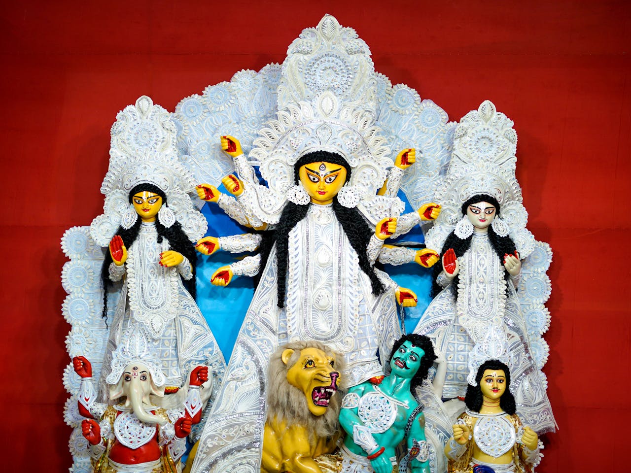 Traditional Durga Puja idols displayed at Kolkata festival, celebrating Hindu goddess.